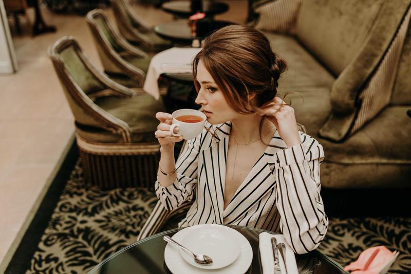 Portrait of girl drinking herbal tea in Orangerie tea room